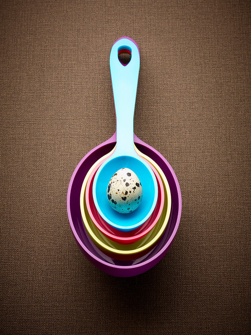 Spotted egg in measuring spoons
