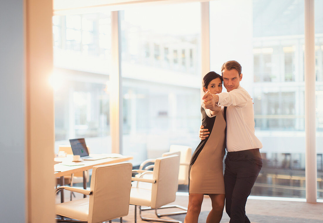 Businessman and businesswoman dancing