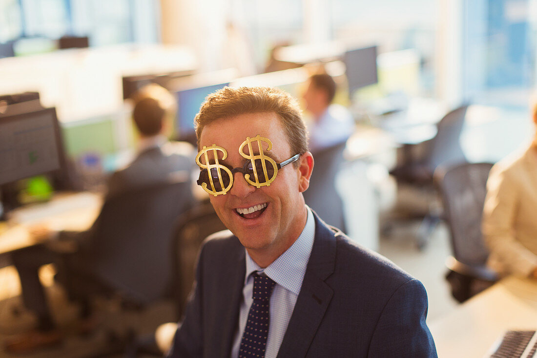 Businessman wearing dollar sign sunglasses