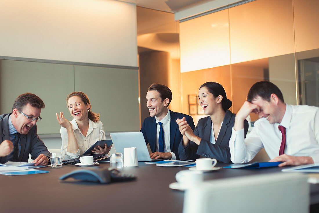 Business people laughing in conference room