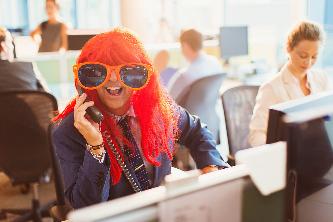 Businessman wearing red wig and huge sunglasses