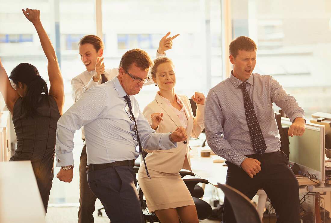 Enthusiastic business people celebrating in office