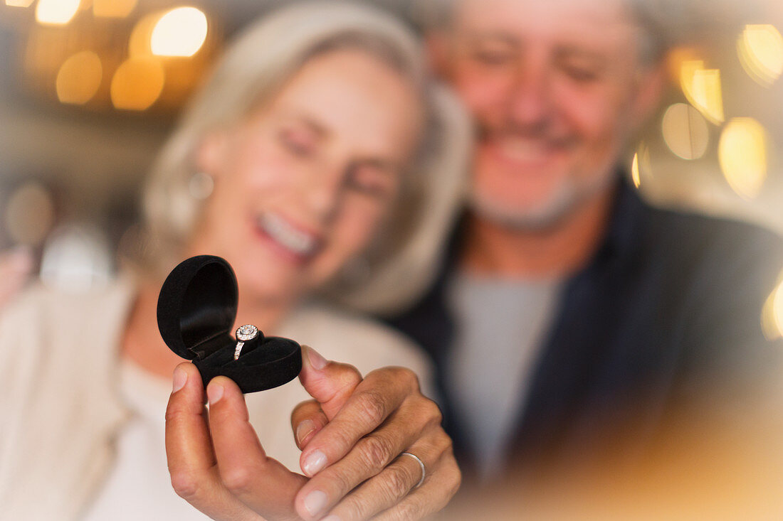 Senior woman receiving ring gift from husband