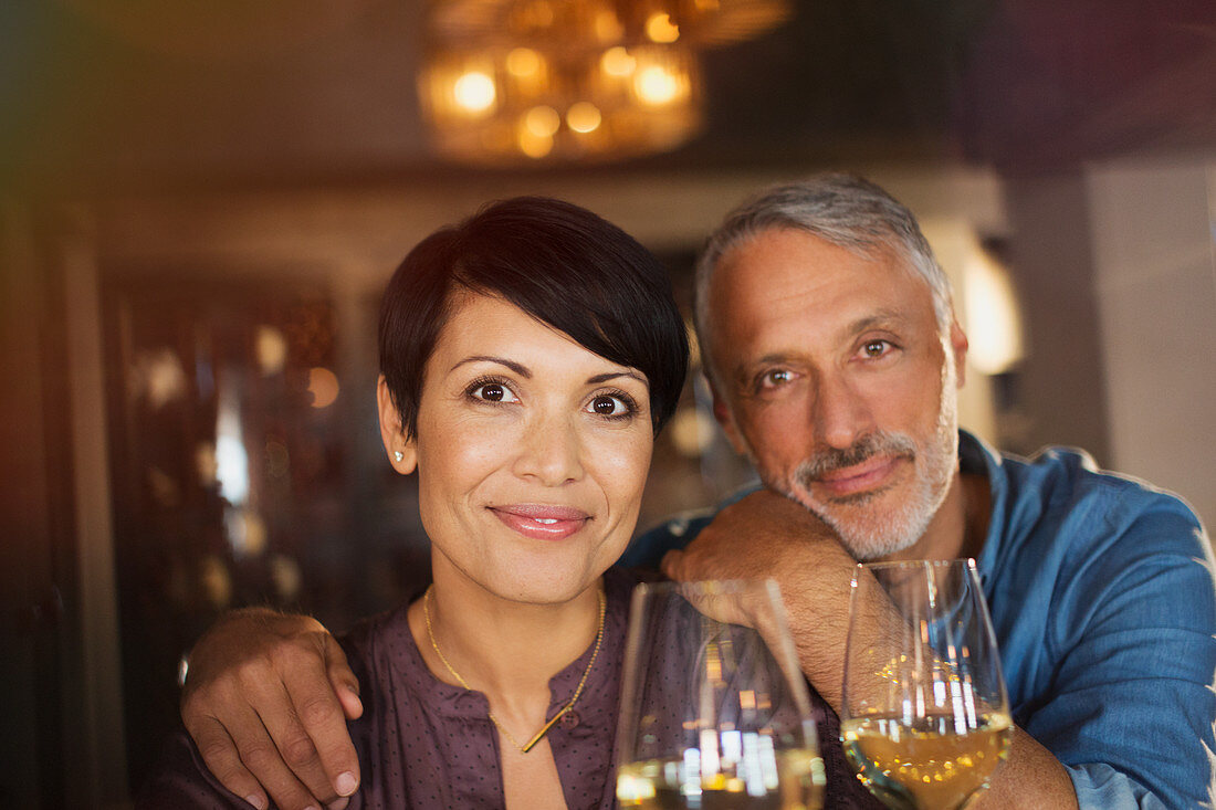 Portrait confident couple drinking white wine