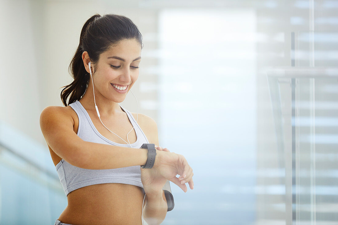Woman exercising checking smart watch