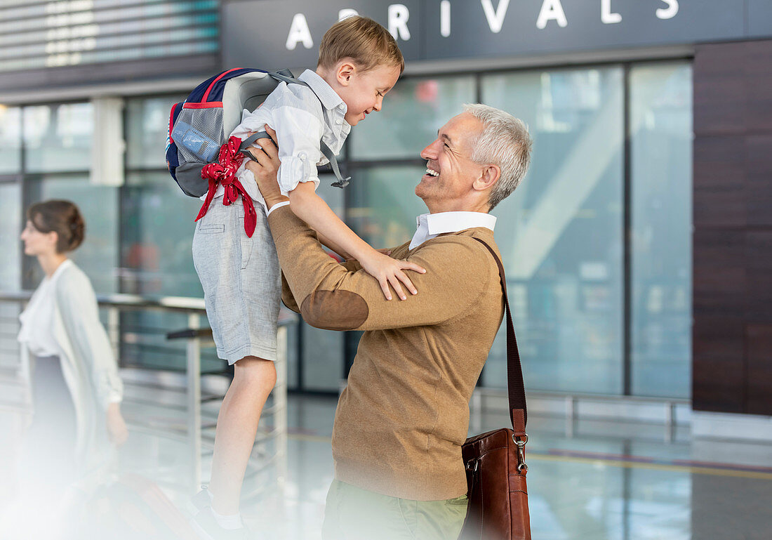 Son greeting father at airport