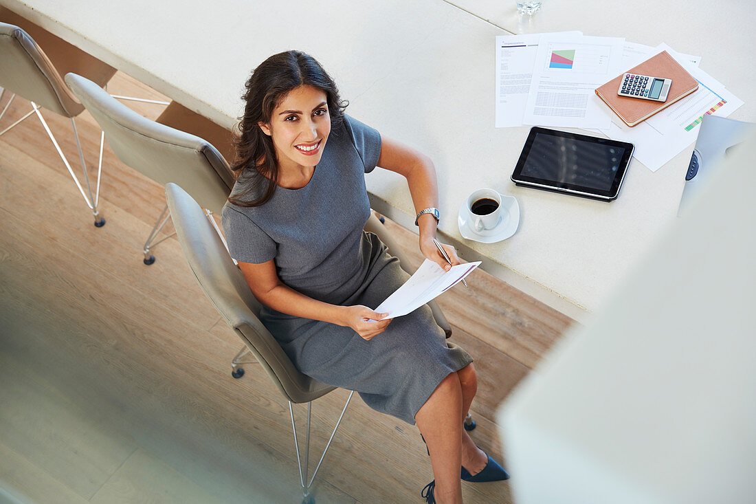 Portrait businesswoman reviewing paperwork