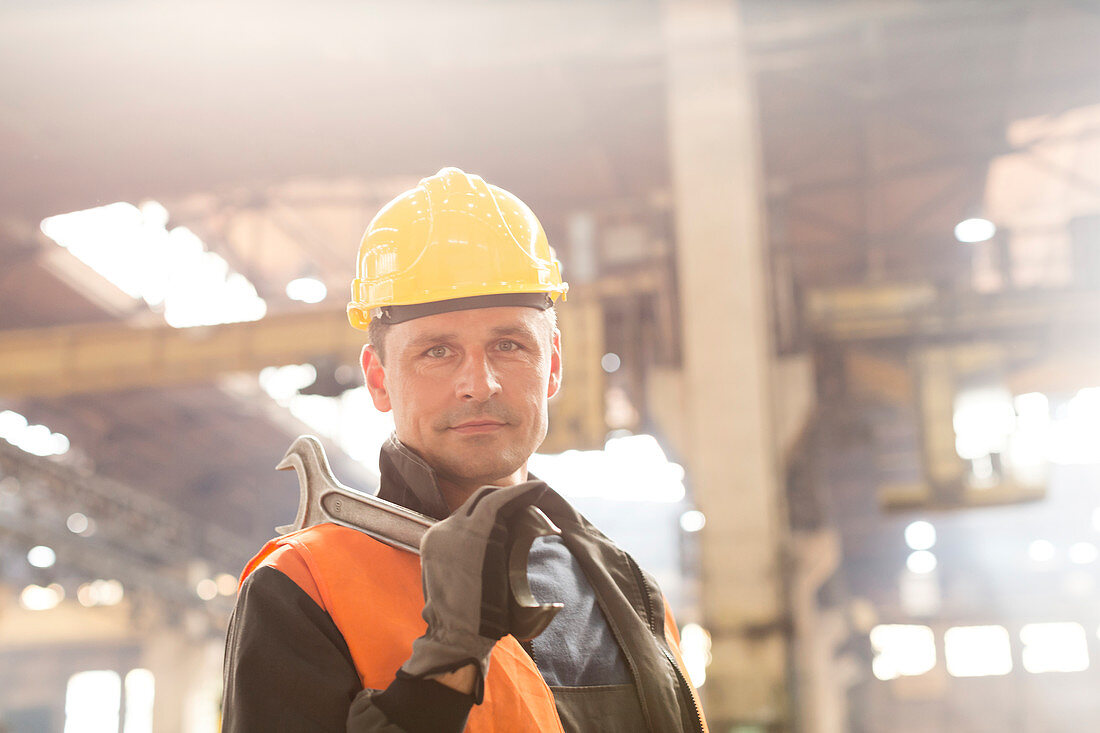 Steel worker holding large wrench