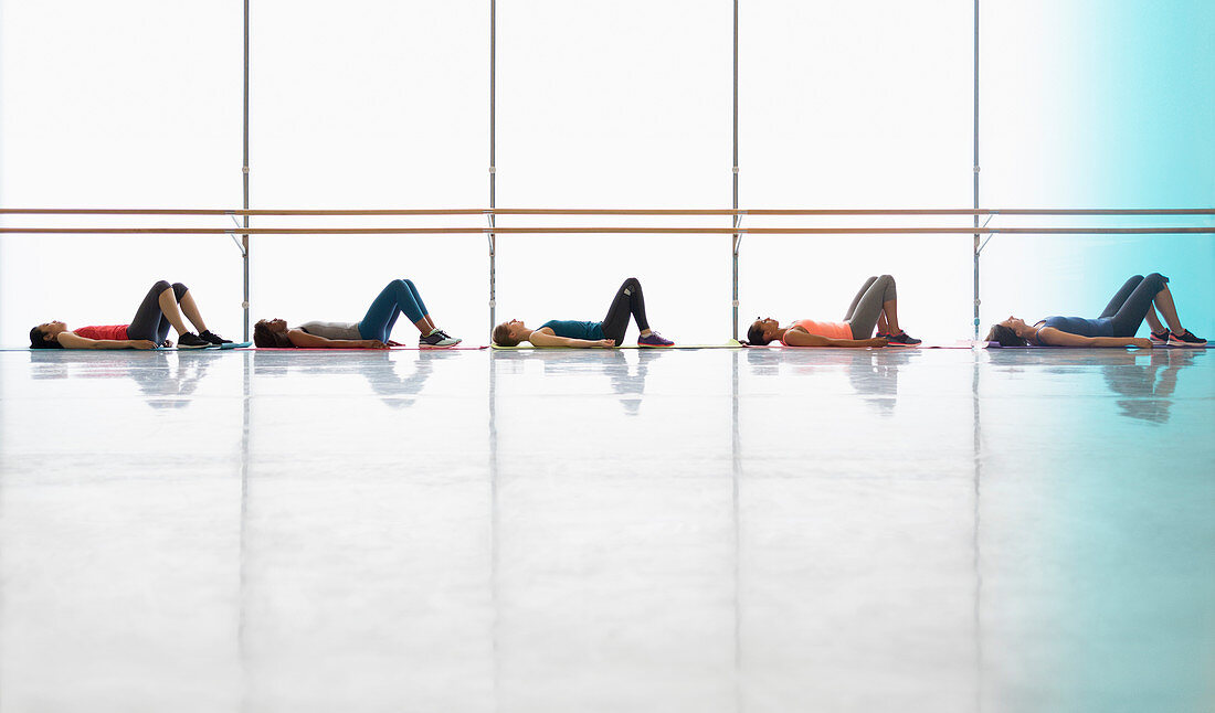 Women resting laying on yoga mats