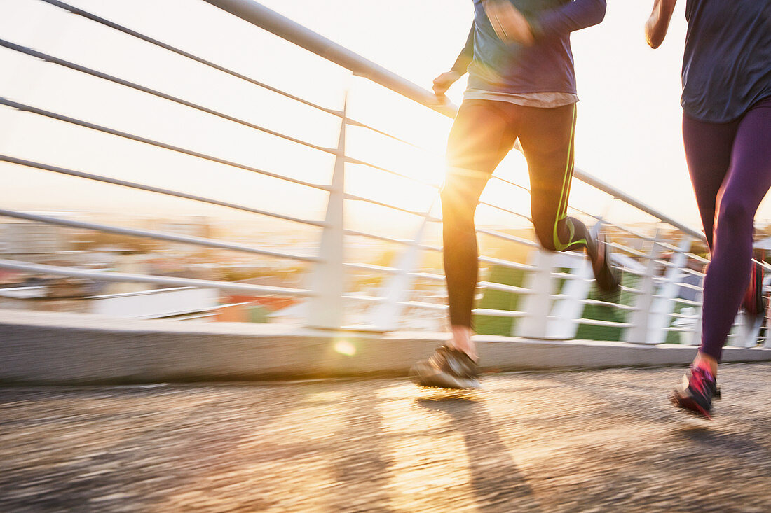 Runner couple running at sunrise