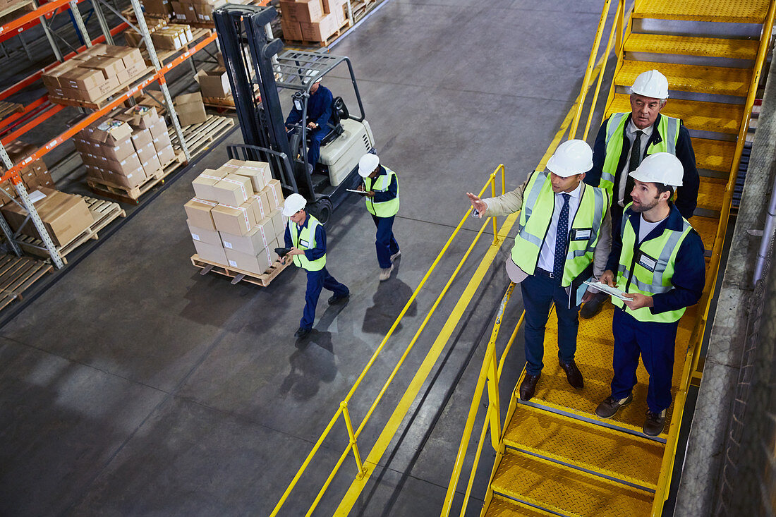 Forklift, managers and workers talking