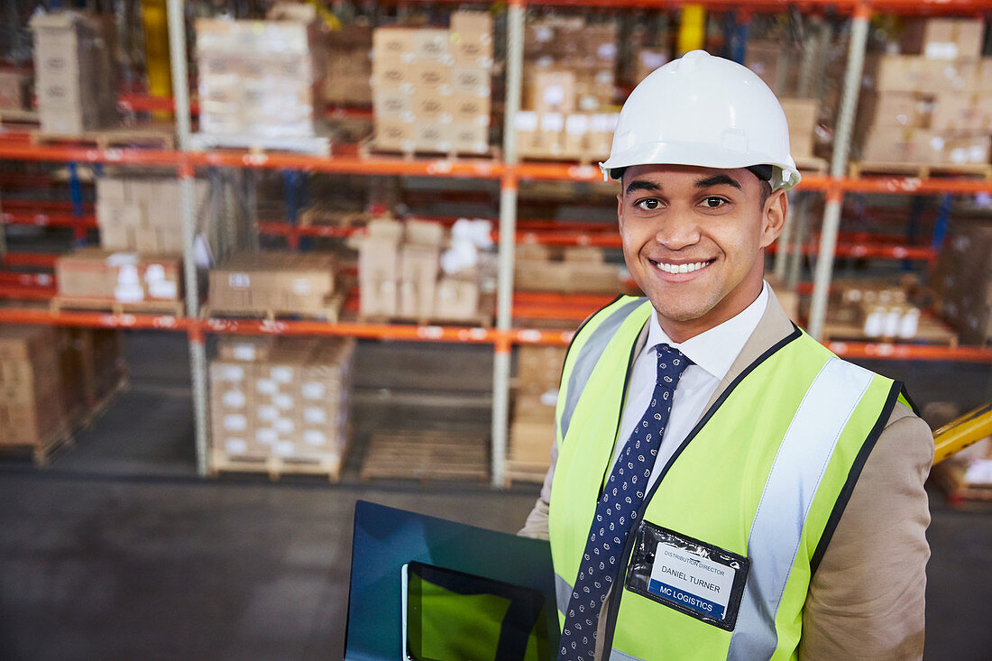 Portrait smiling manager in distribution warehouse