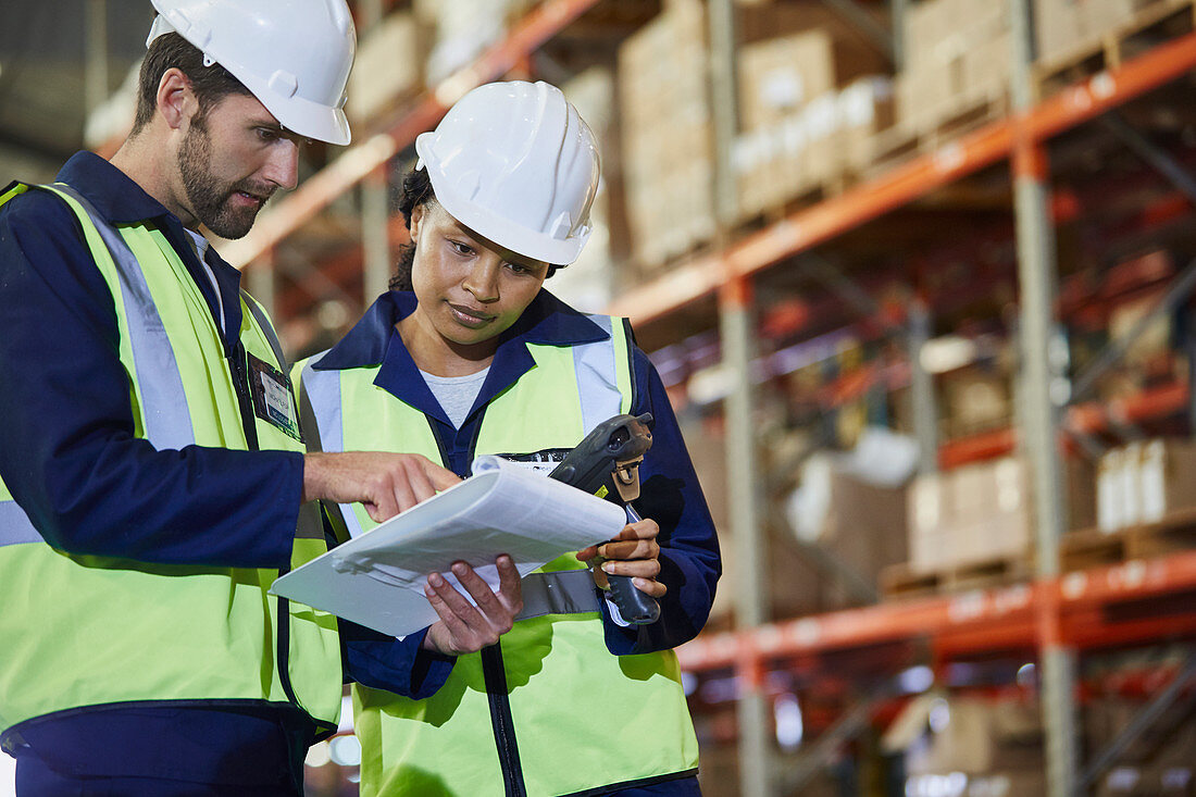 Workers with scanner and clipboard talking