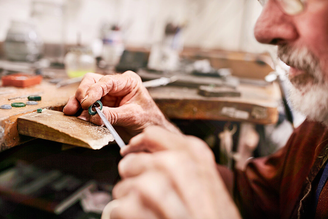 Male jeweller making jewellery in workshop