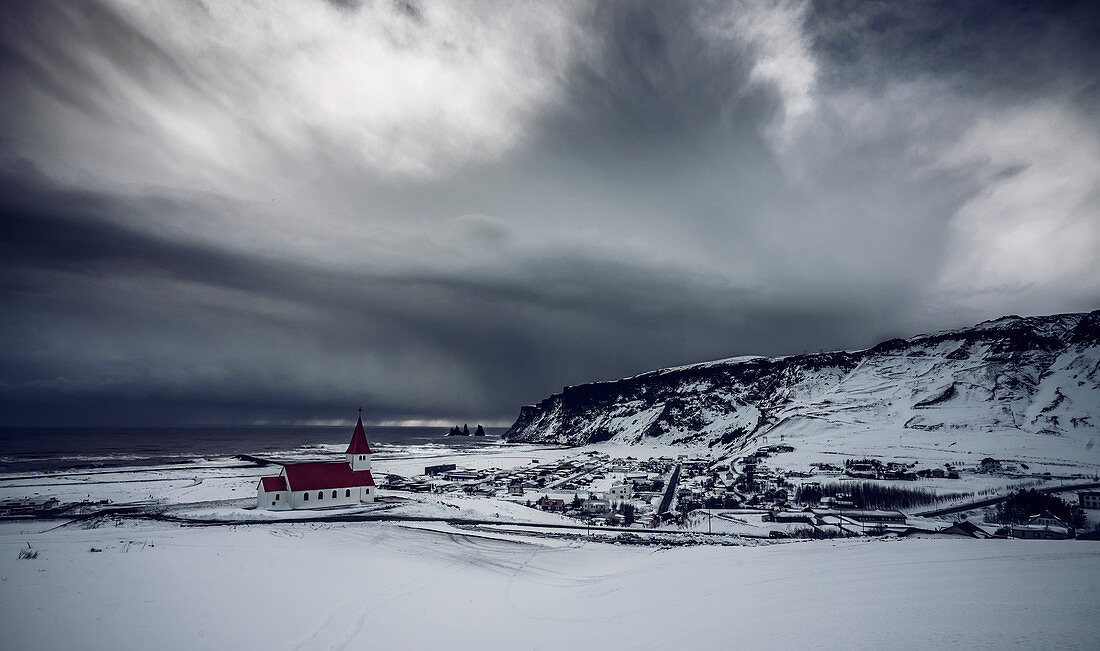 Church in snow covered landscape, Vik, Iceland