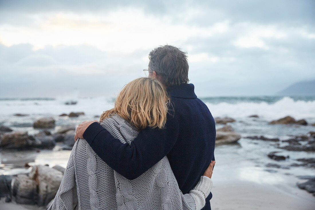 Serene couple hugging on winter beach