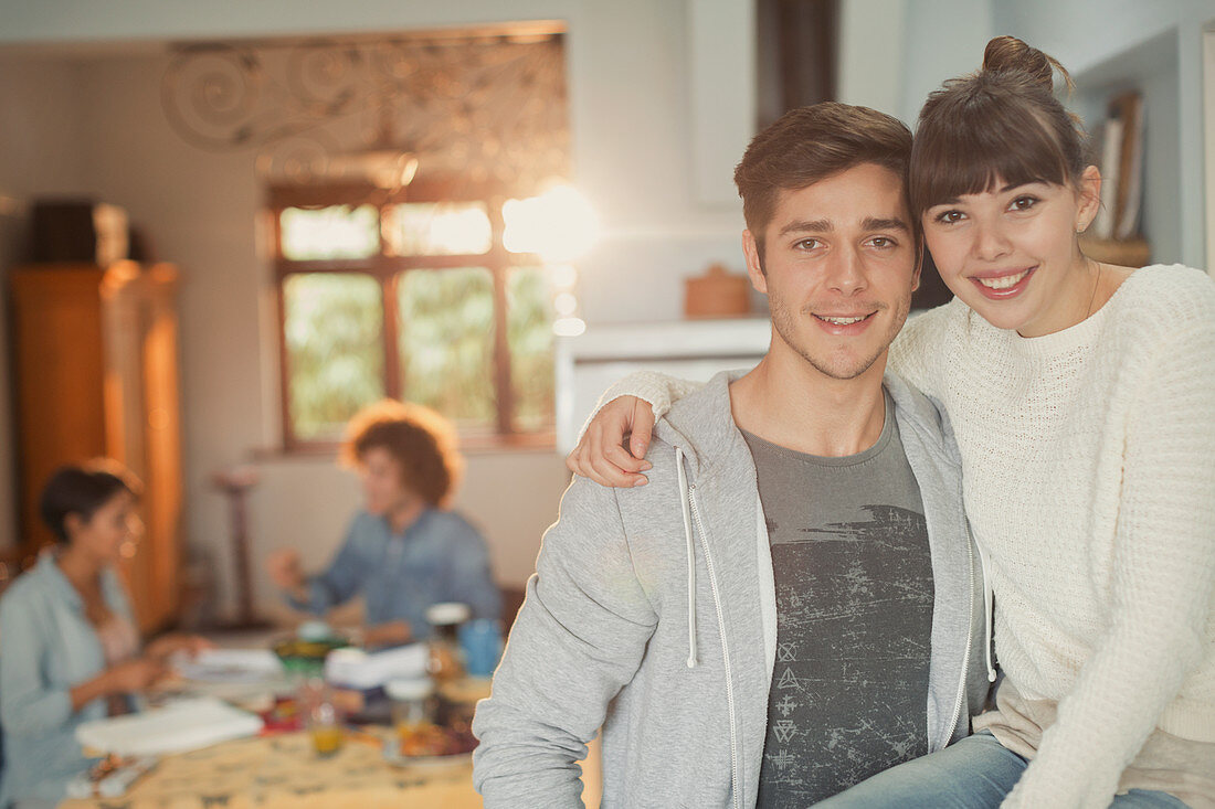 Portrait smiling young couple hugging