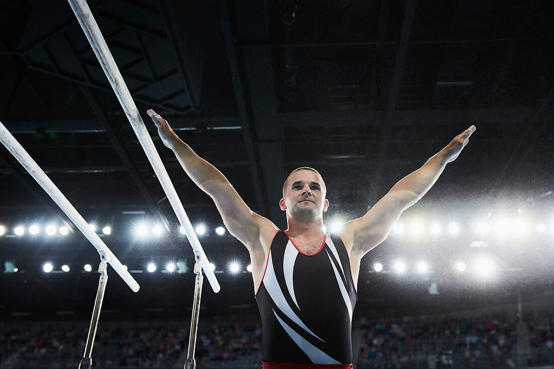 Male gymnast next to parallel bars