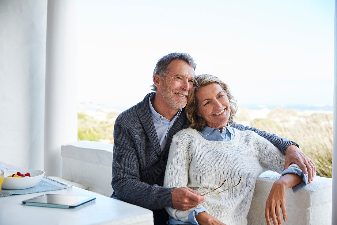 Smiling senior couple relaxing on patio