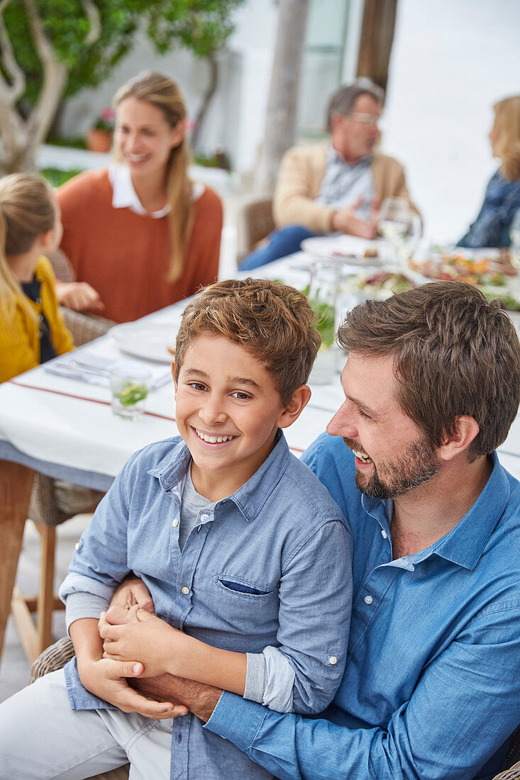 Father and son enjoying patio lunch