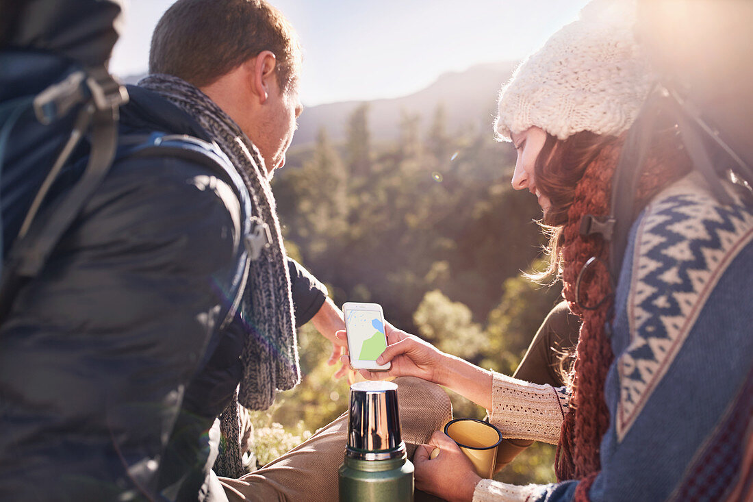 Young couple hiking, taking a coffee