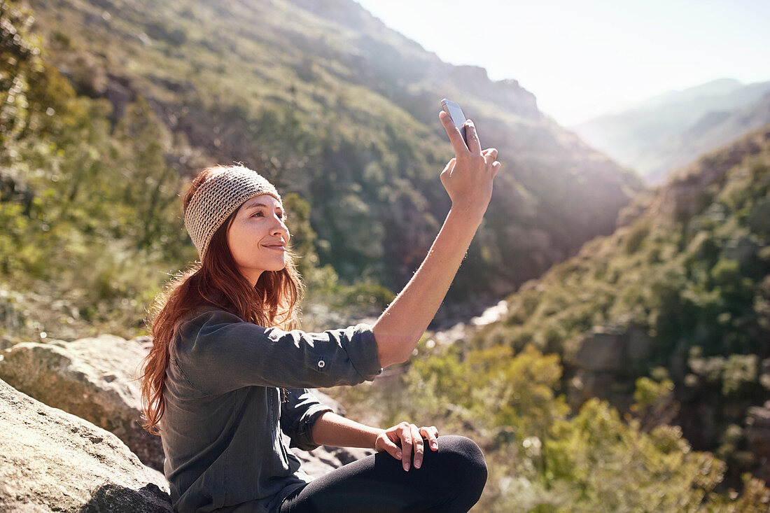 Young woman taking selfie with camera phone