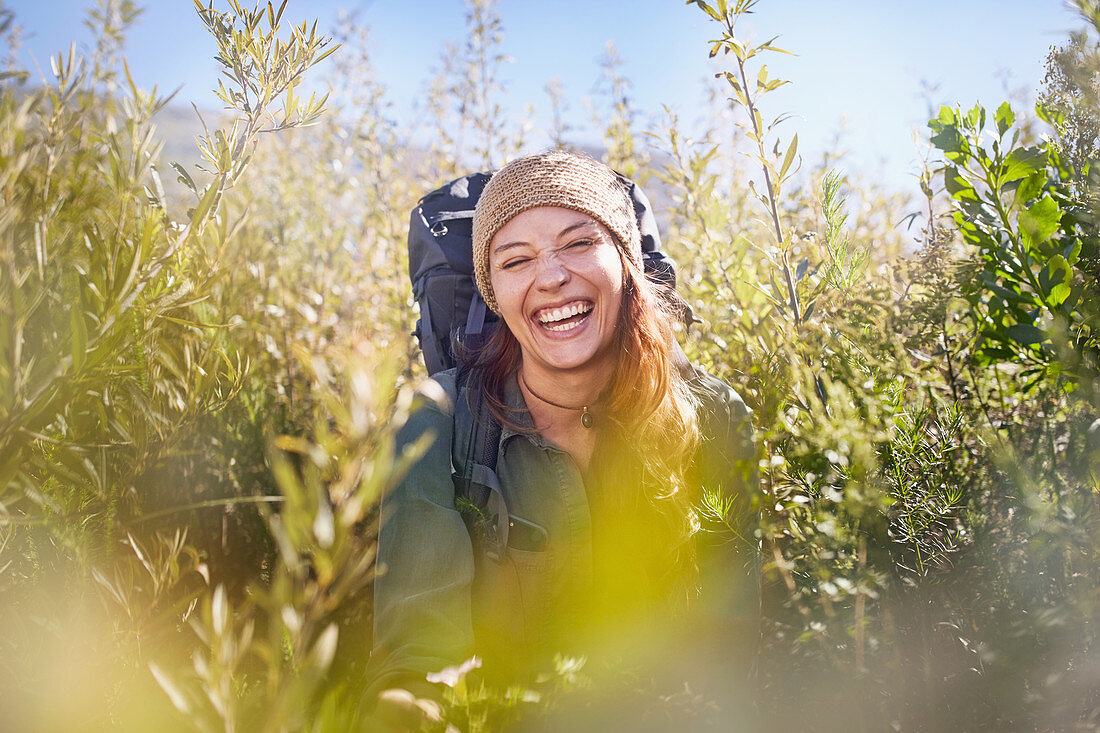 Portrait laughing young woman with backpack