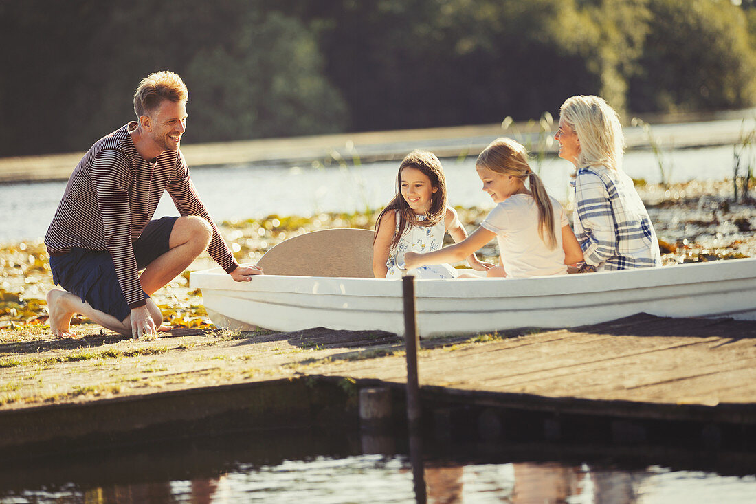 Family in canoe at lake dock