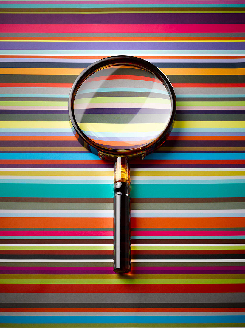 Magnifying glass on striped background