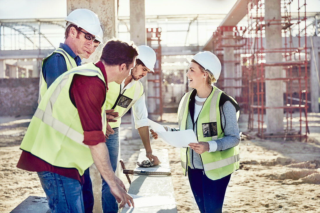 Female foreman talking to construction workers