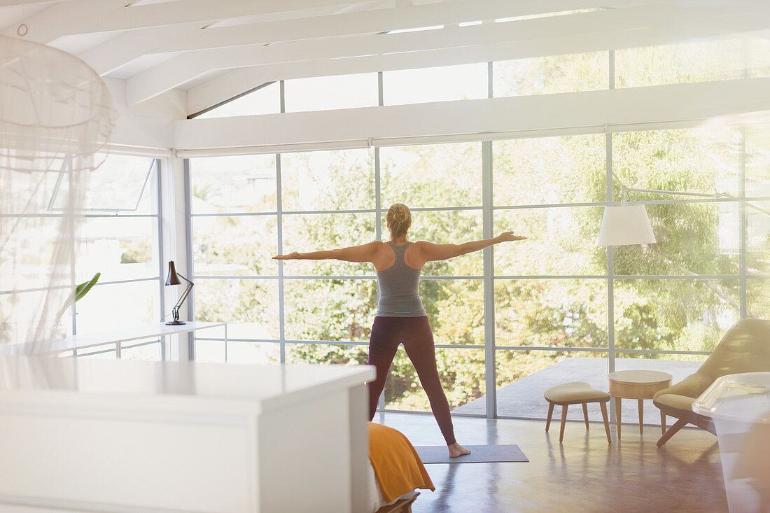 Woman practicing yoga with arms outstretched