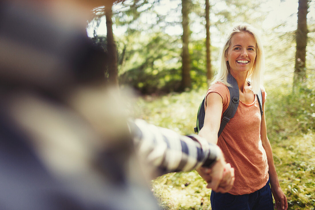 Smiling couple holding hands hiking