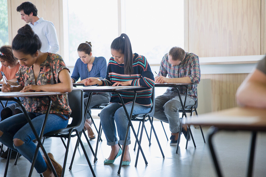 College students taking test at desks