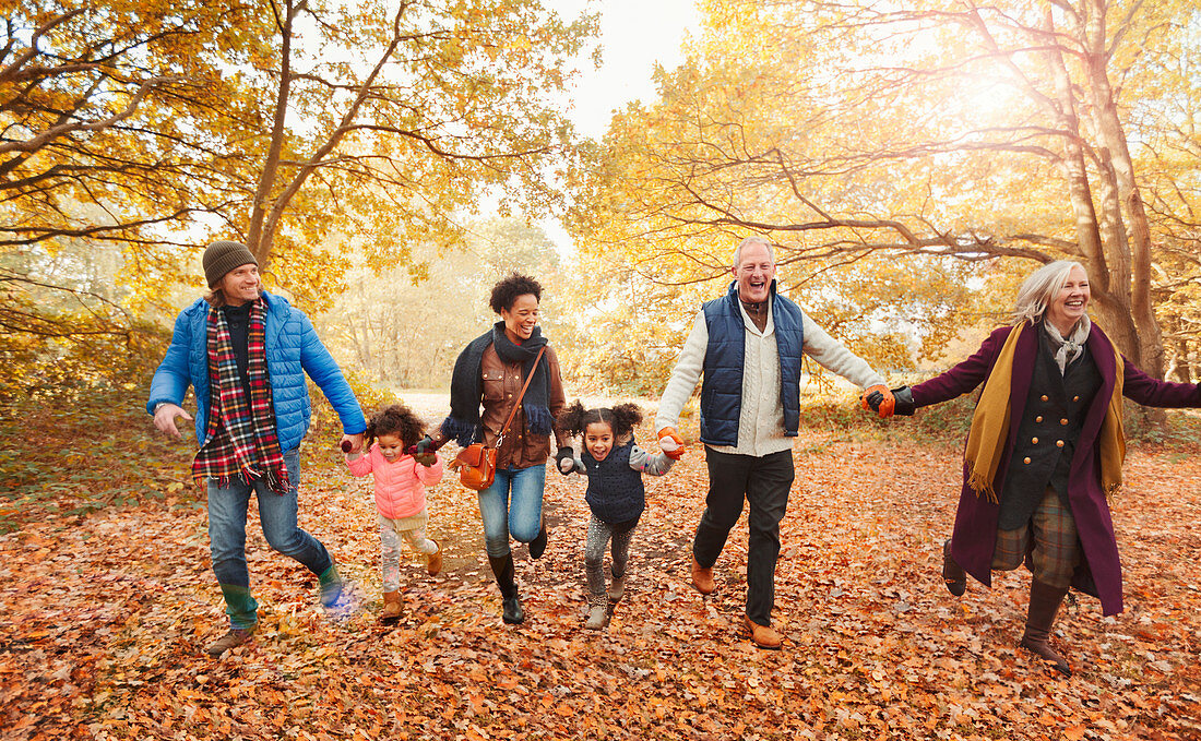 Playful family running in autumn park