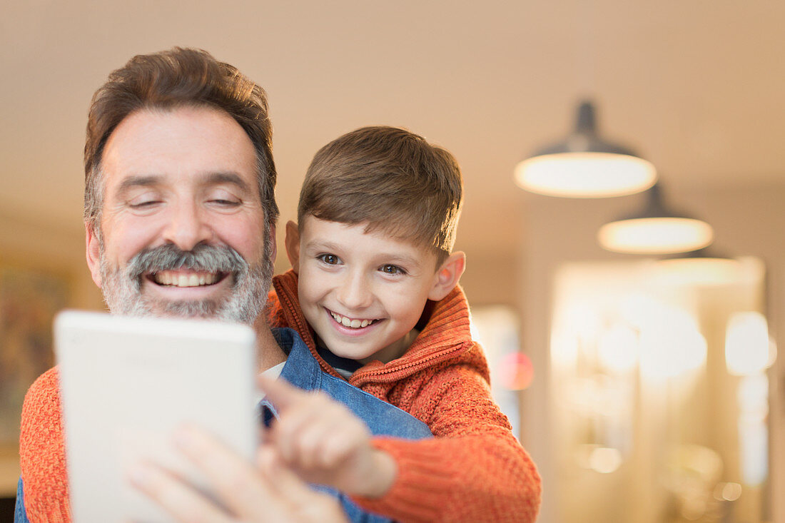 Father and son bonding, sharing tablet