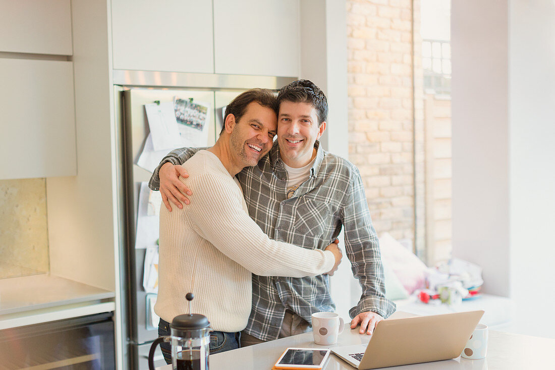 Portrait affectionate male gay couple hugging