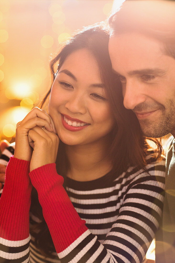 Close up, affectionate couple looking away