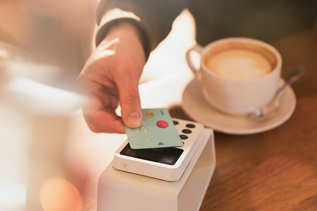 Man paying for cappuccino with credit card