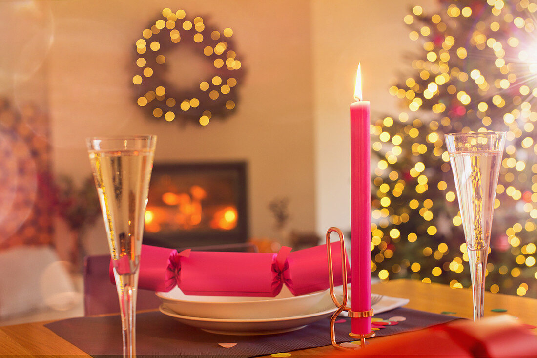 Champagne flute, candle and Christmas cracker