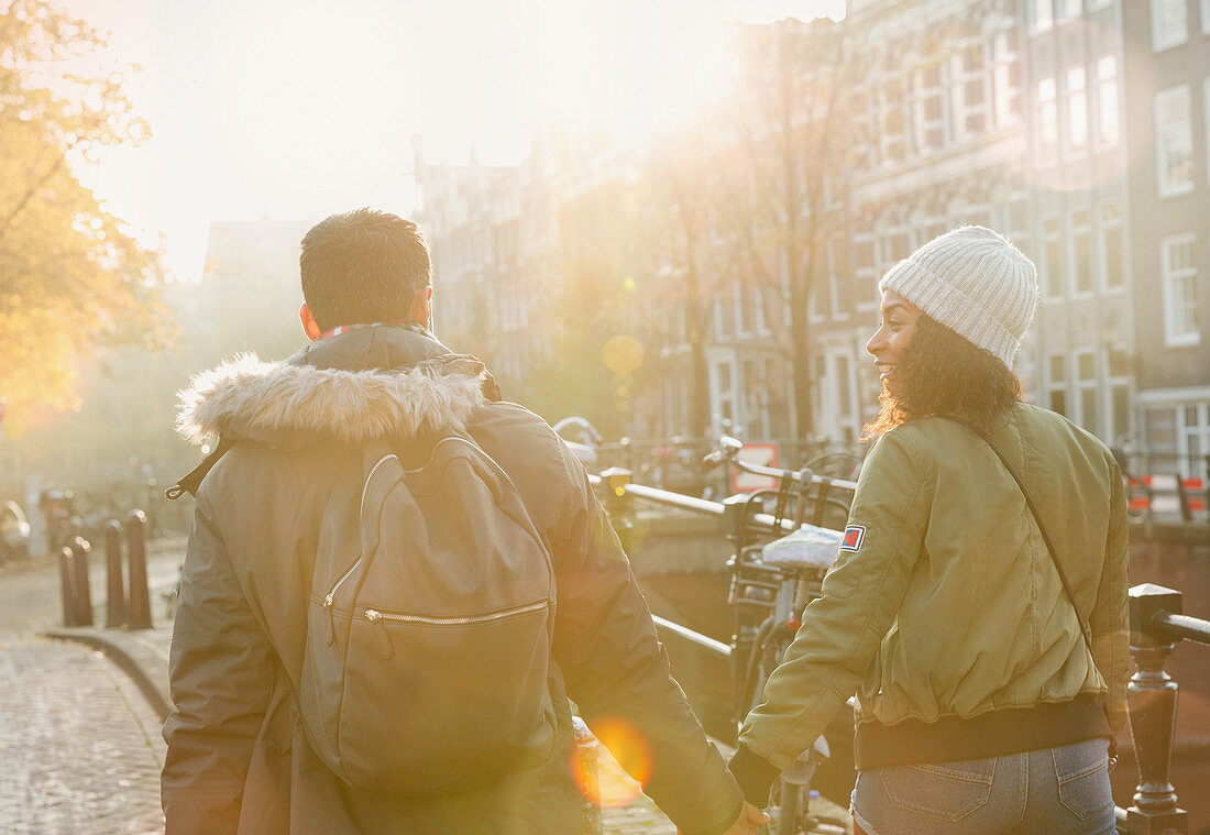 Young couple holding hands walking