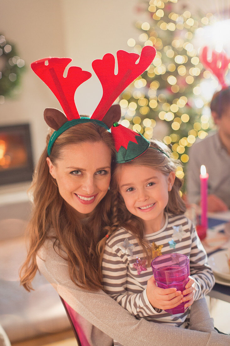 Mother and daughter wearing reindeer antlers