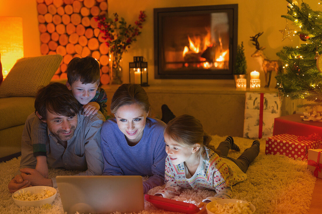 Family watching video in Christmas living room
