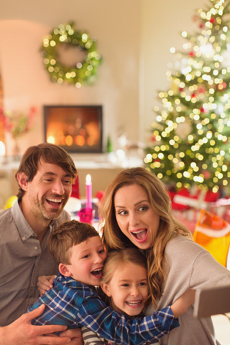 Family taking selfie in Christmas living room