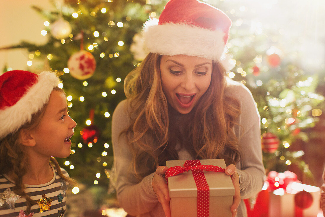Mother receiving Christmas gift from daughter