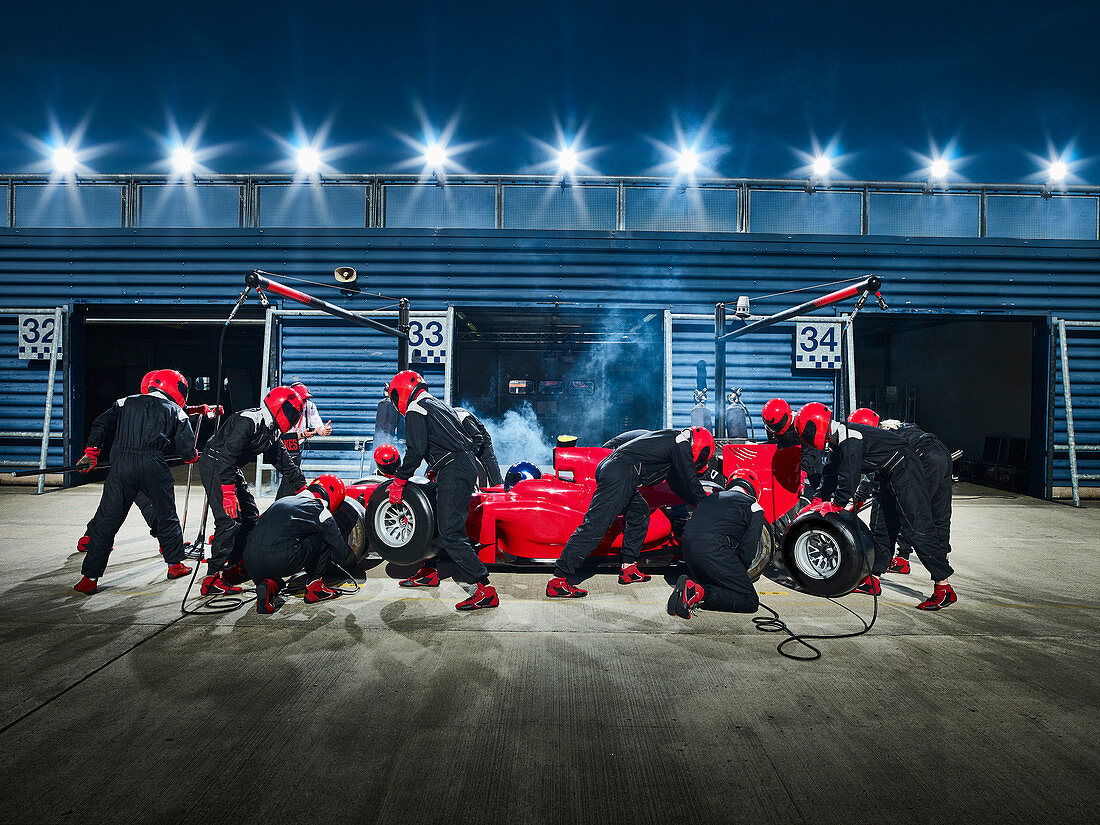 Pit crew working on formula one race car