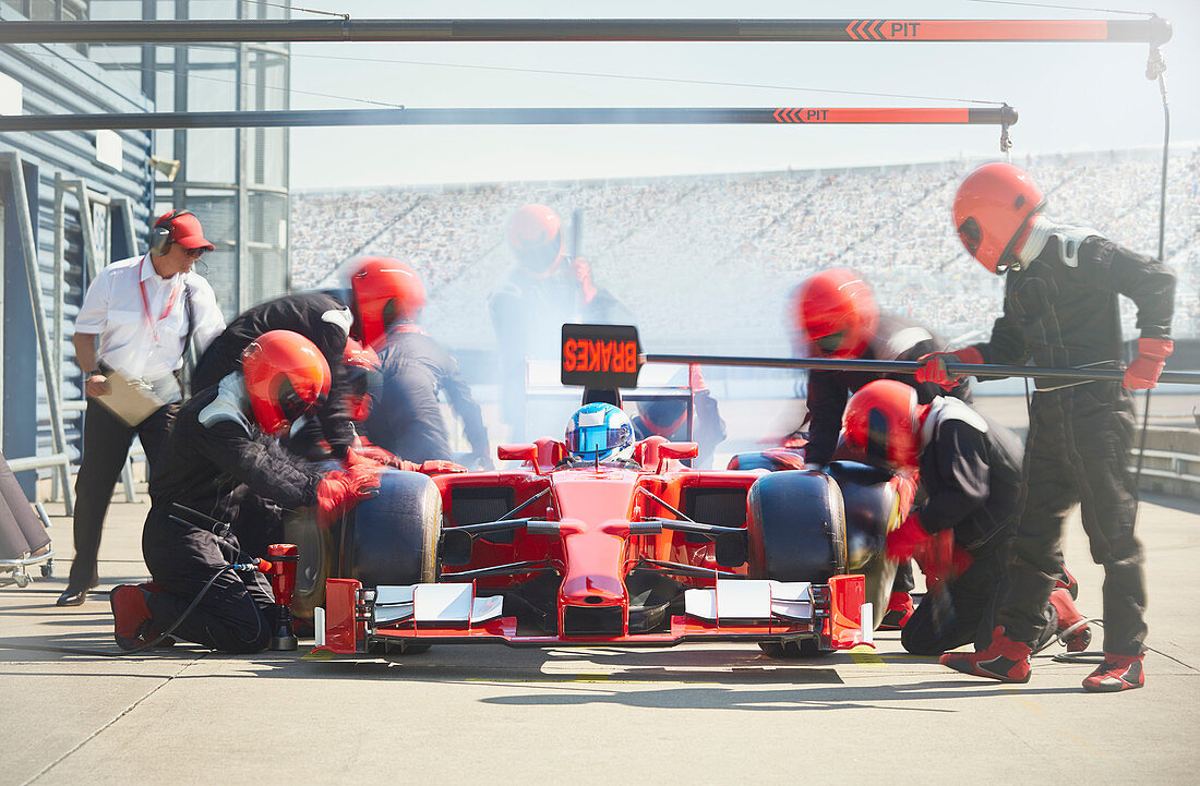 Pit crew working on formula one race car