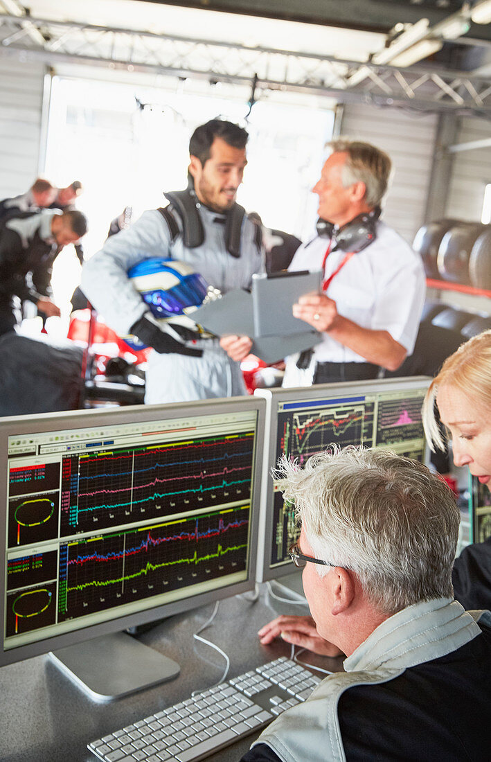 Formula one team reviewing diagnostics