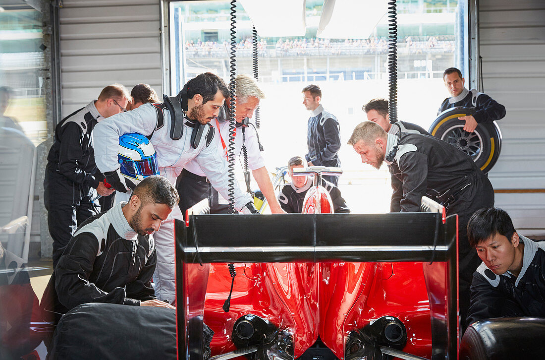 Pit crew preparing formula one race car