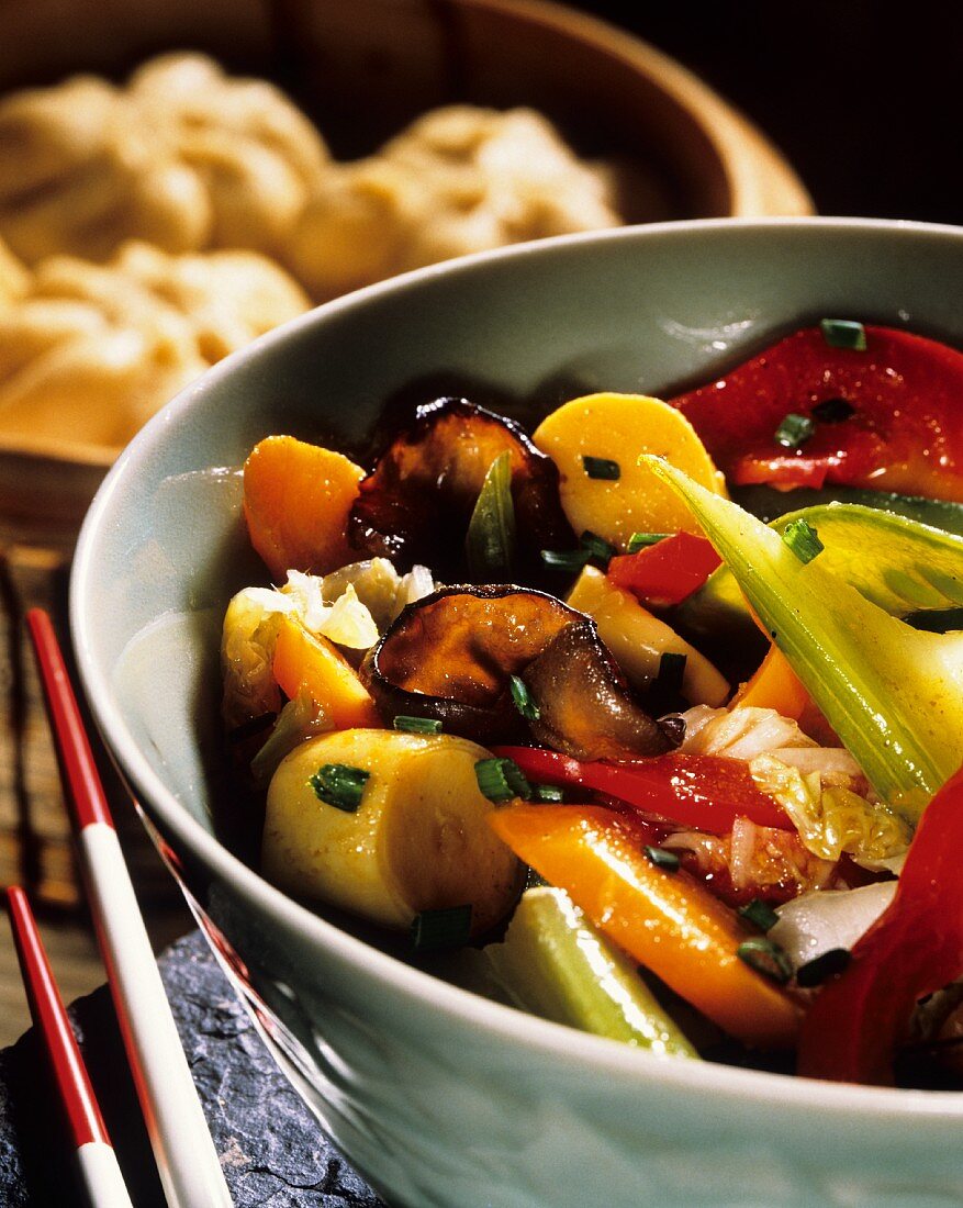 Chinese fried vegetables in bowls & yeast dumplings