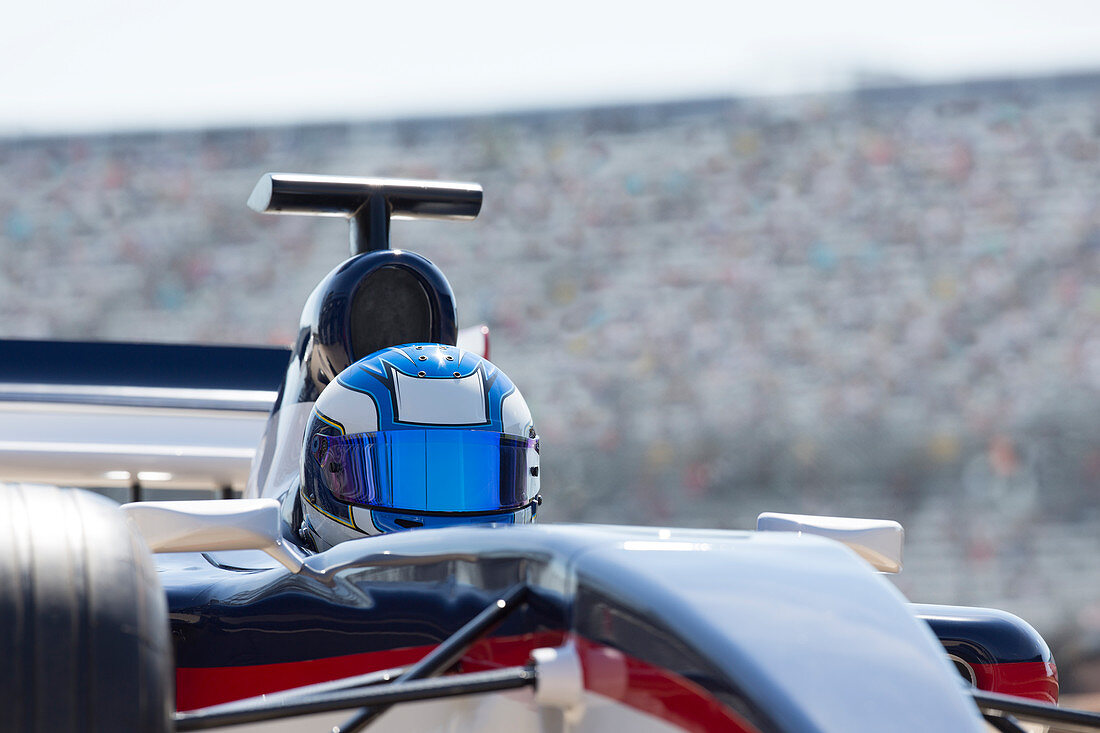 Formula one race car driver wearing helmet